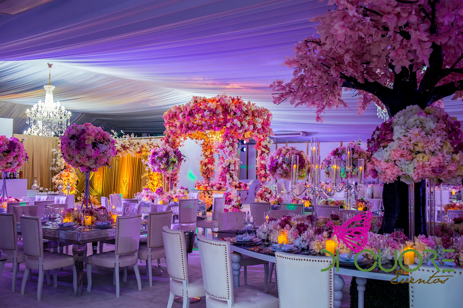 Hall with the floral canopy at its centre, crystal chandeliers, mirrored tables and a pink blossom tree beneath the draped ceiling.
