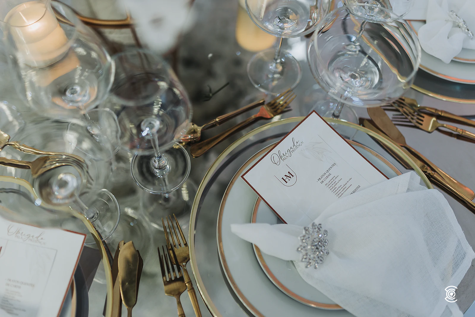 Overhead view of glasses, gold cutlery and menus