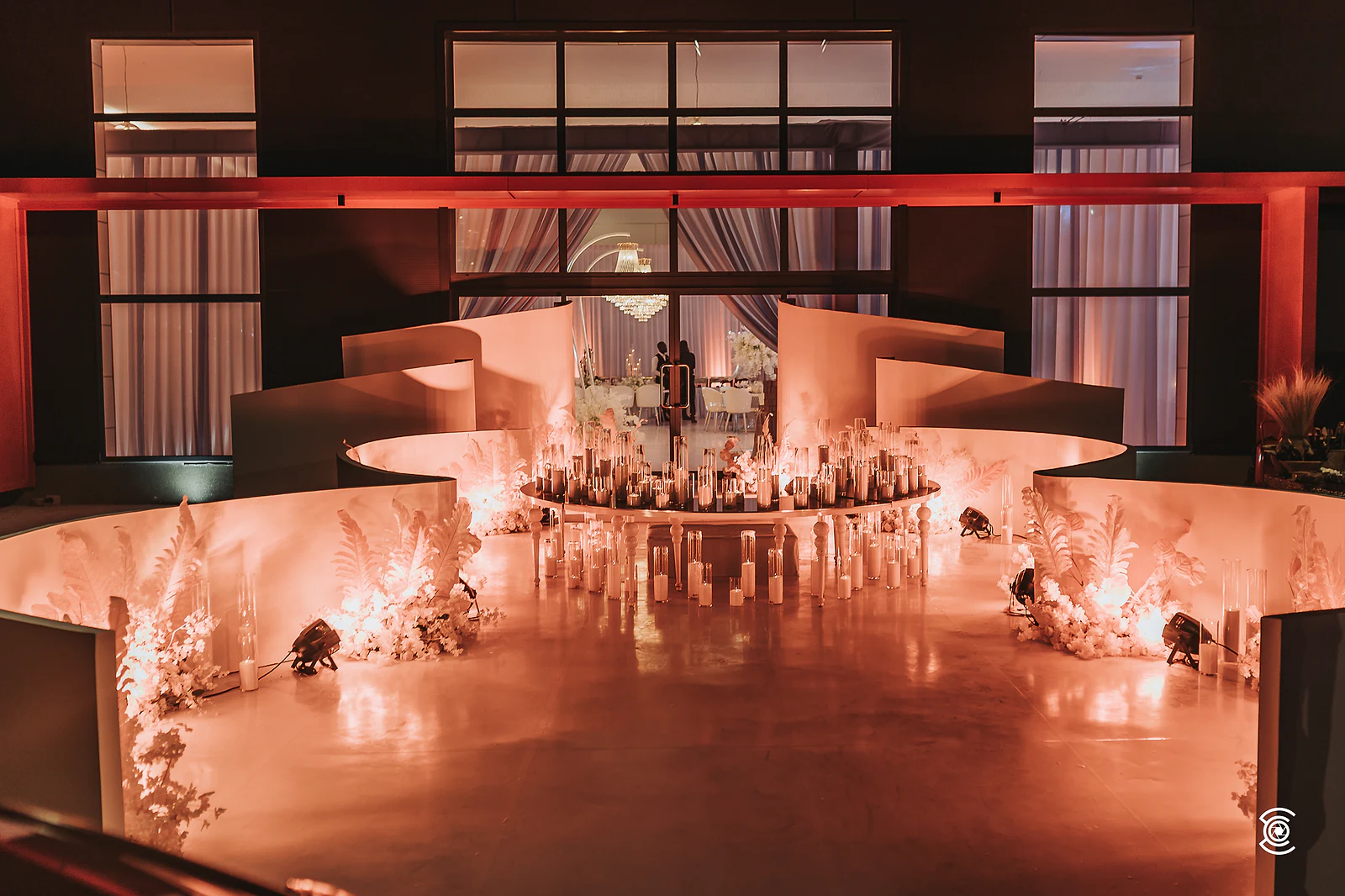 Ballroom in shades of orange and red, with the top table in the centre