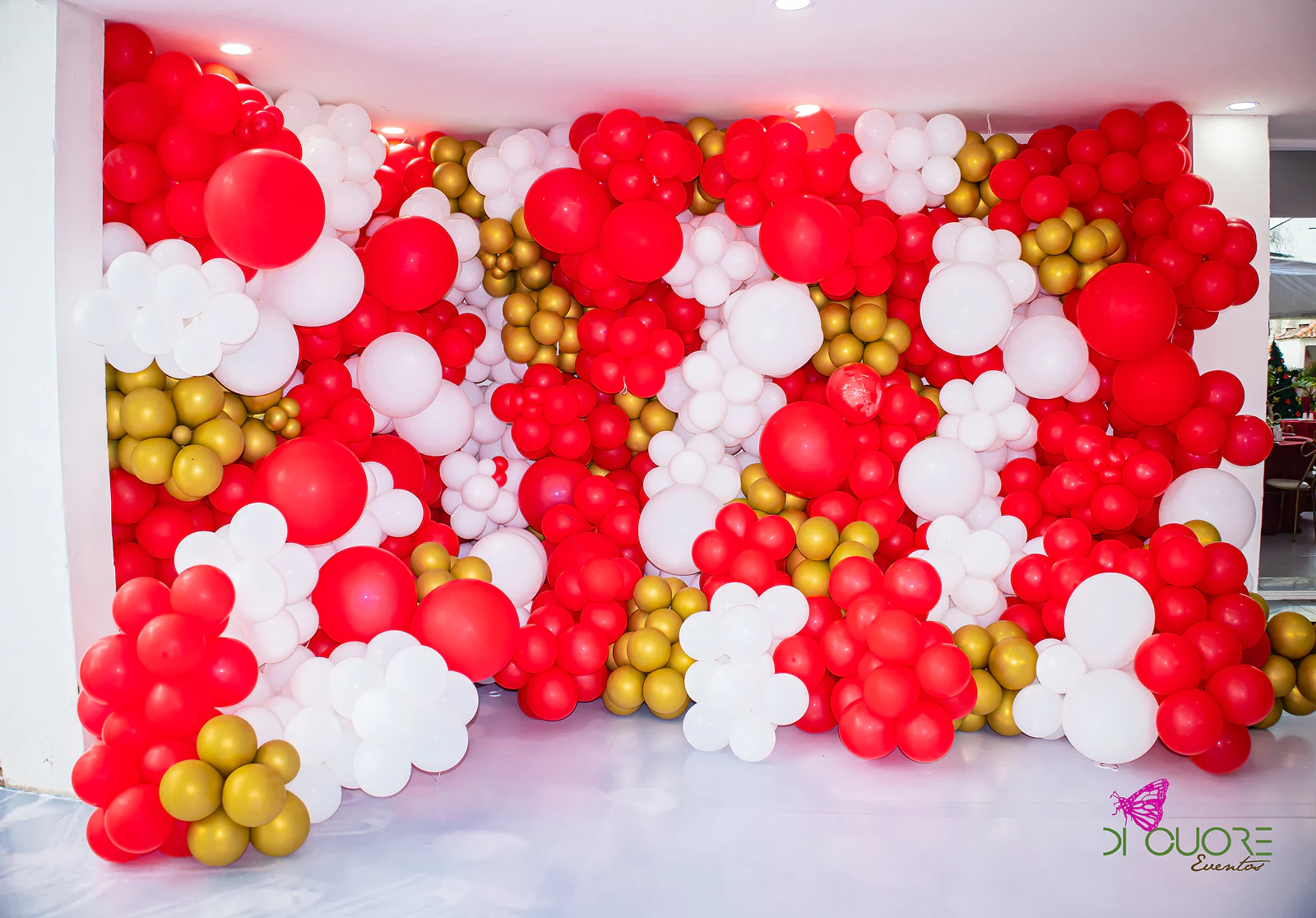 Wall of red, white and gold balloons in assorted sizes